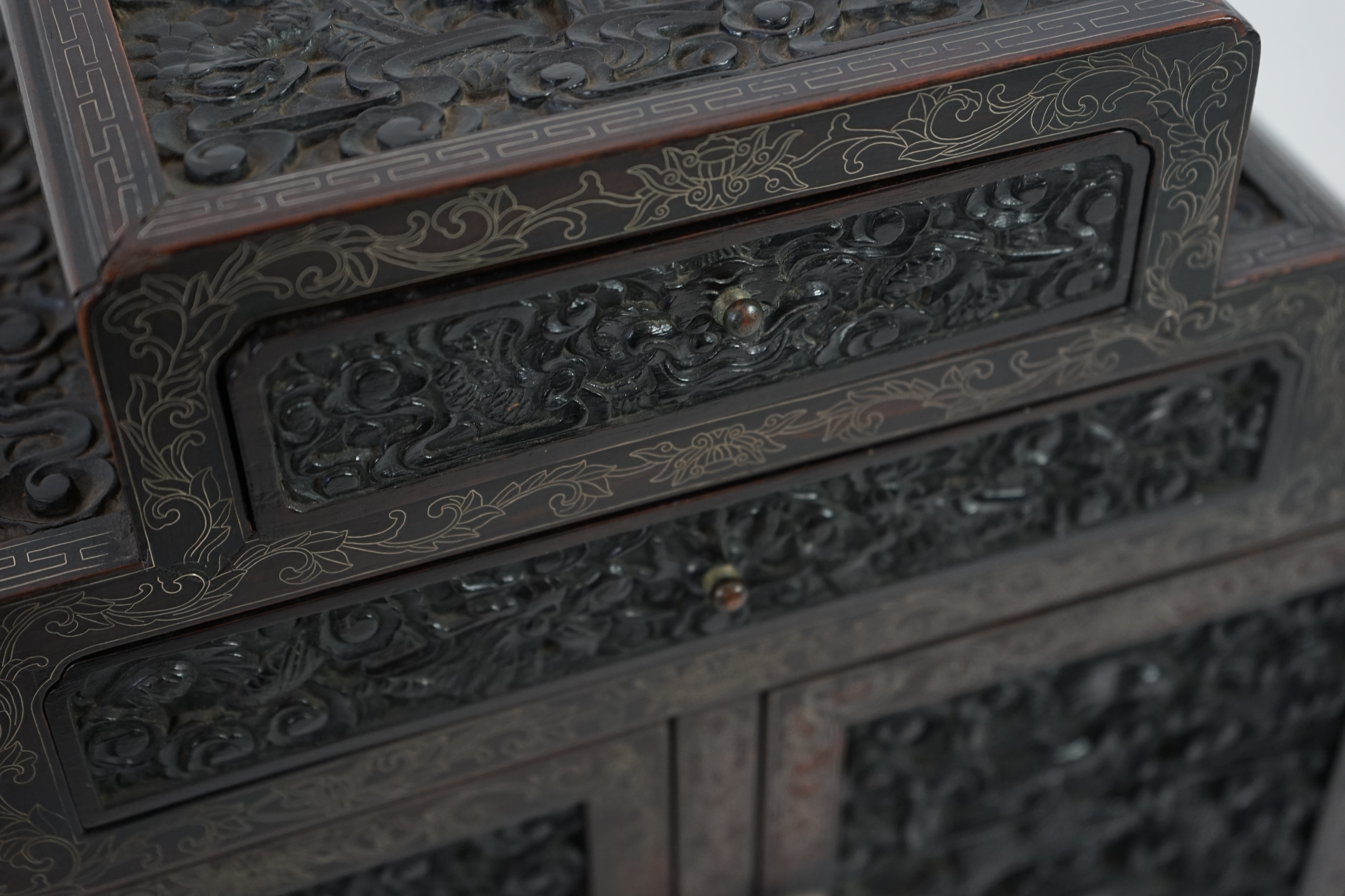 An important pair of Chinese carved zitan and silver wire inlaid ‘cloud and dragon’ curio cabinets and stands, duobaoge, probably Imperial, late Qing dynasty